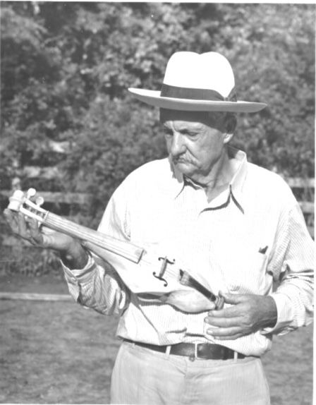 Sevan John Guedry with a Horsehead fiddle that he carved