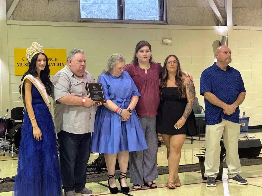 Seth's parents Carl and Loyce Guidry, his widow Courtney Richards and his sister Hilary Guidry accepting Seth's Hall of Fame plaque