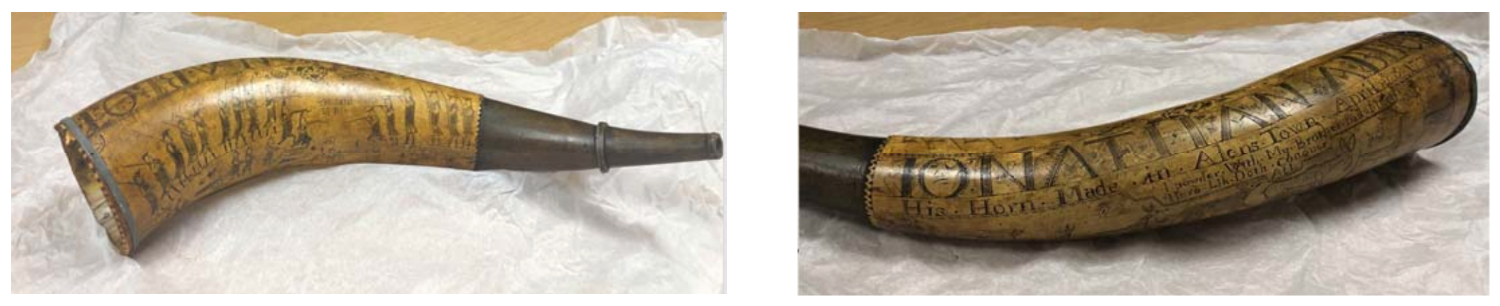 Close-up of the powder horn showing carved battle scenes with soldiers, artillery and engraved lettering